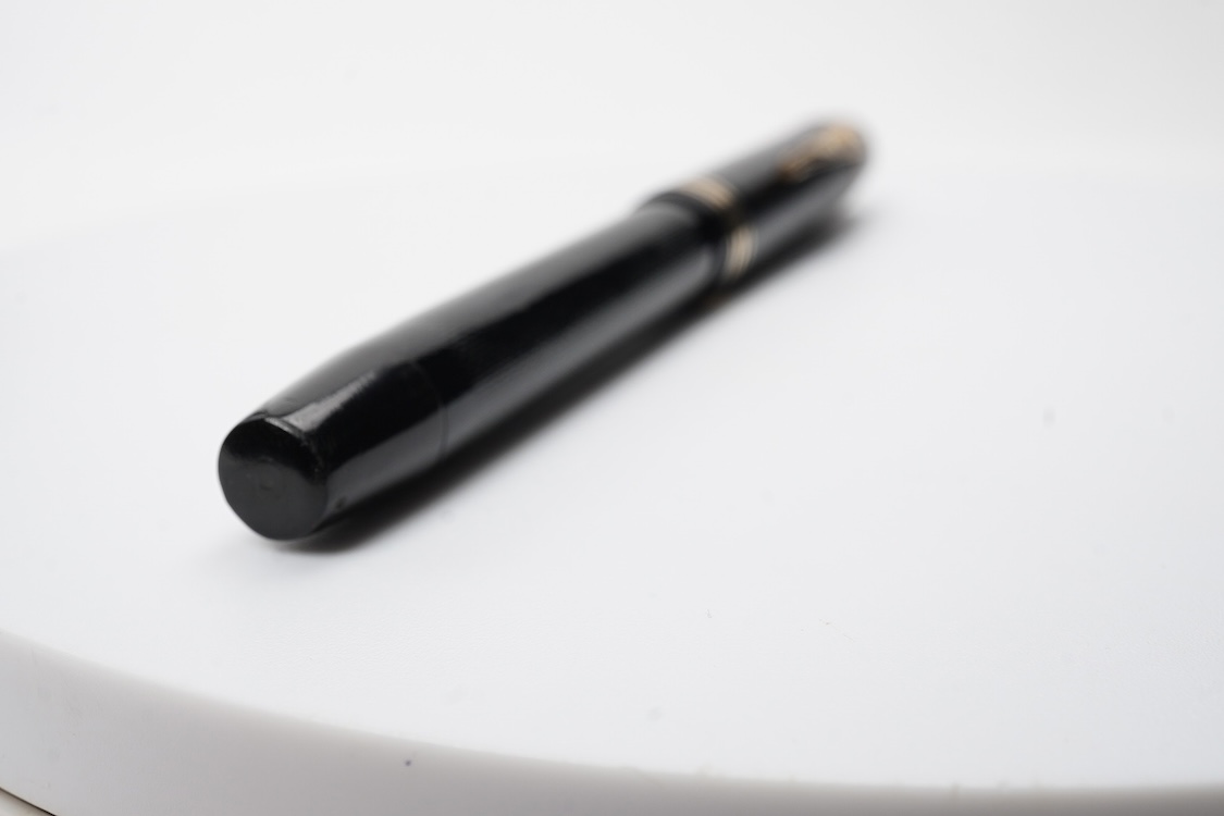 A De la Rue Onoto piston fill fountain pen in large size with ornate cap banding and fitted with DLR Onoto No.5 14ct. nib